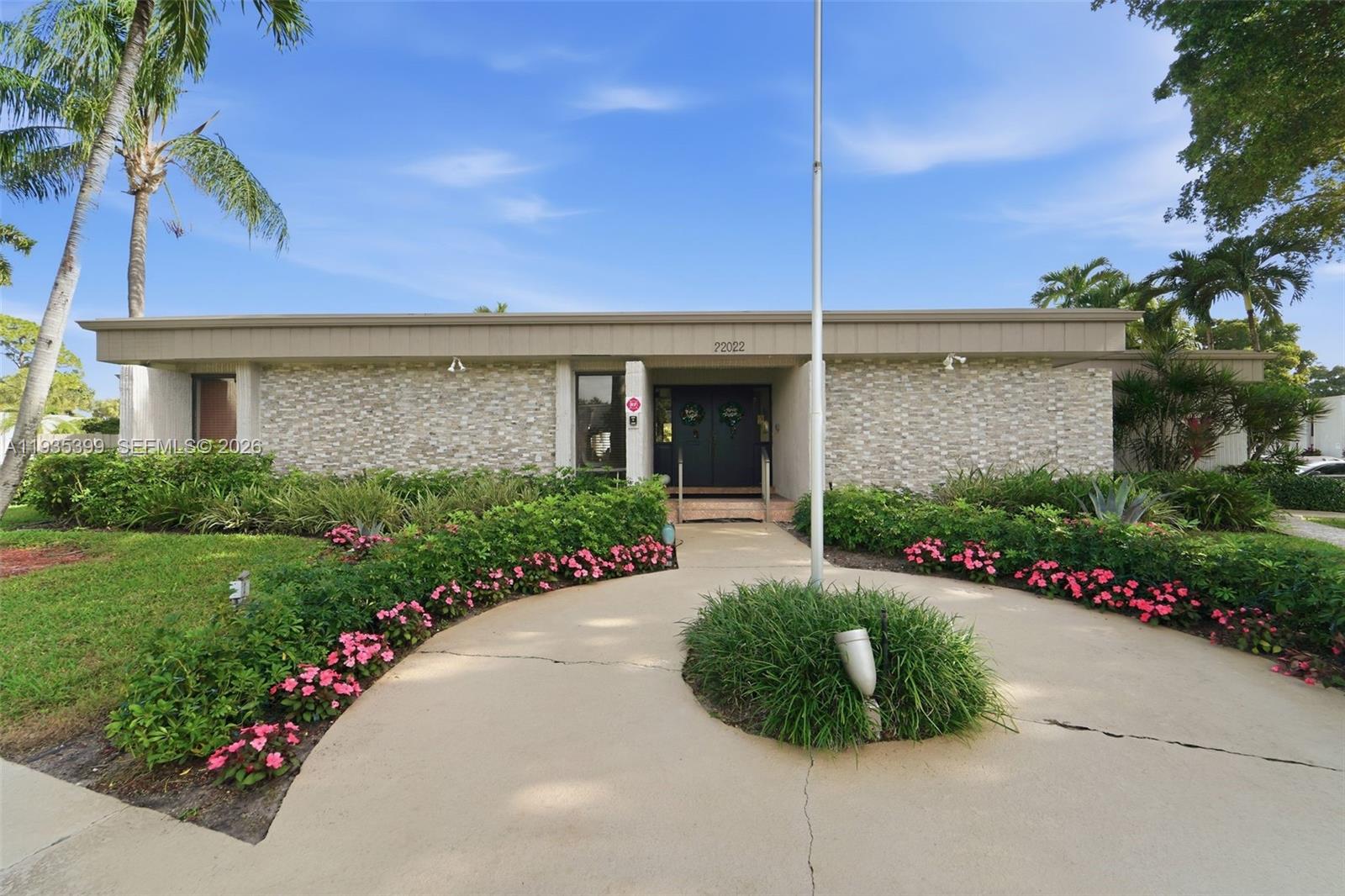 6561 Spring Bottom Way, Unit 234 Boca Raton, FL 33433 - Photo 28 of 33 a front view of a house with a garden
