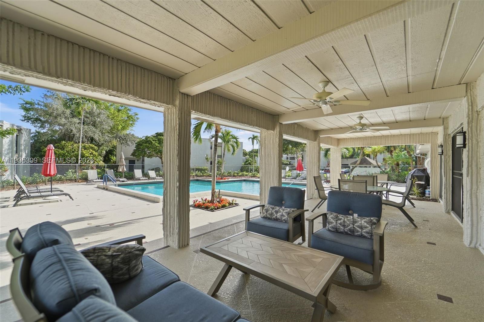6561 Spring Bottom Way, Unit 234 Boca Raton, FL 33433 - Photo 29 of 33 a living room with furniture and a floor to ceiling window