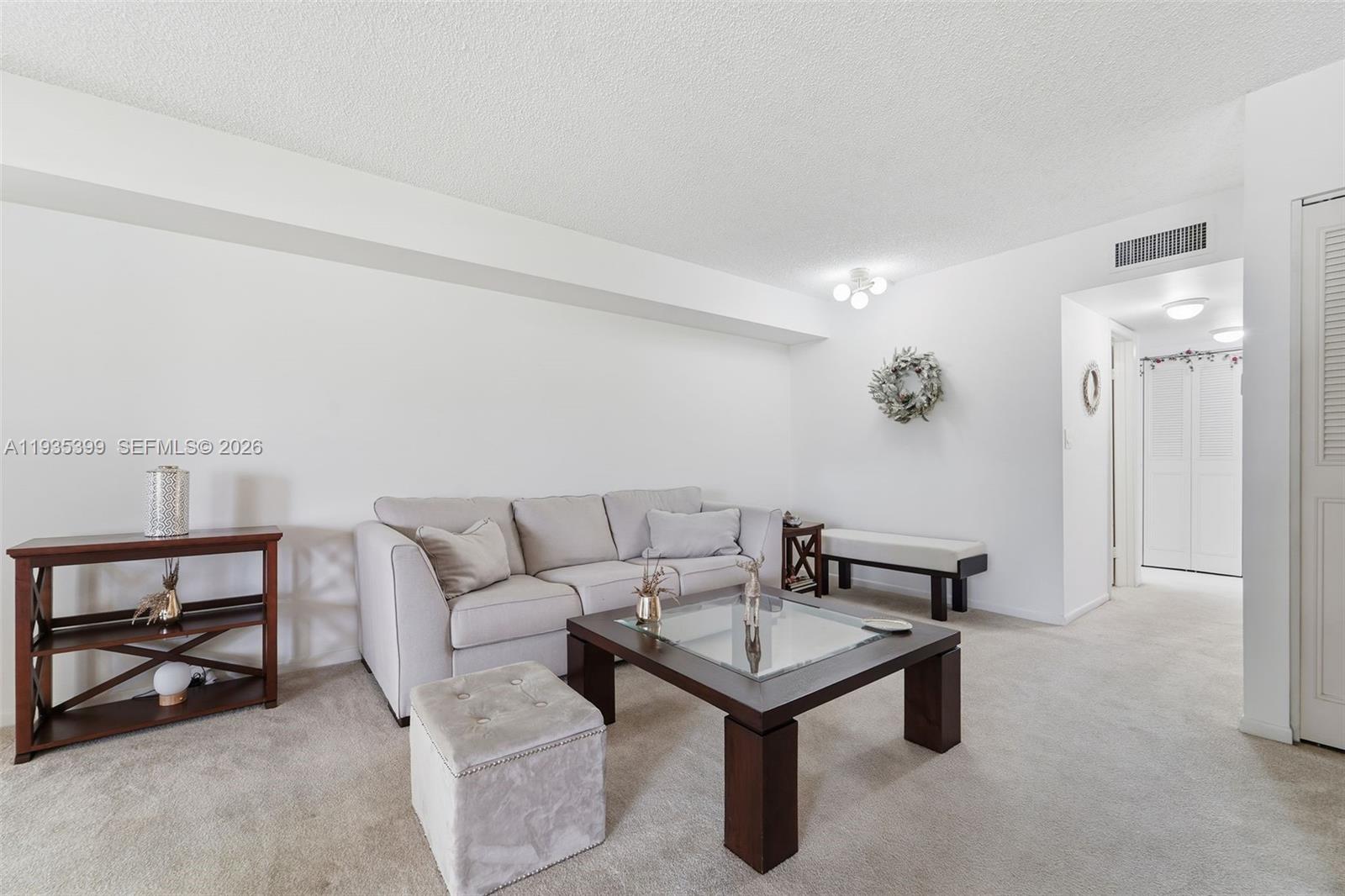 6561 Spring Bottom Way, Unit 234 Boca Raton, FL 33433 - Photo 7 of 33 a living room with furniture and a table