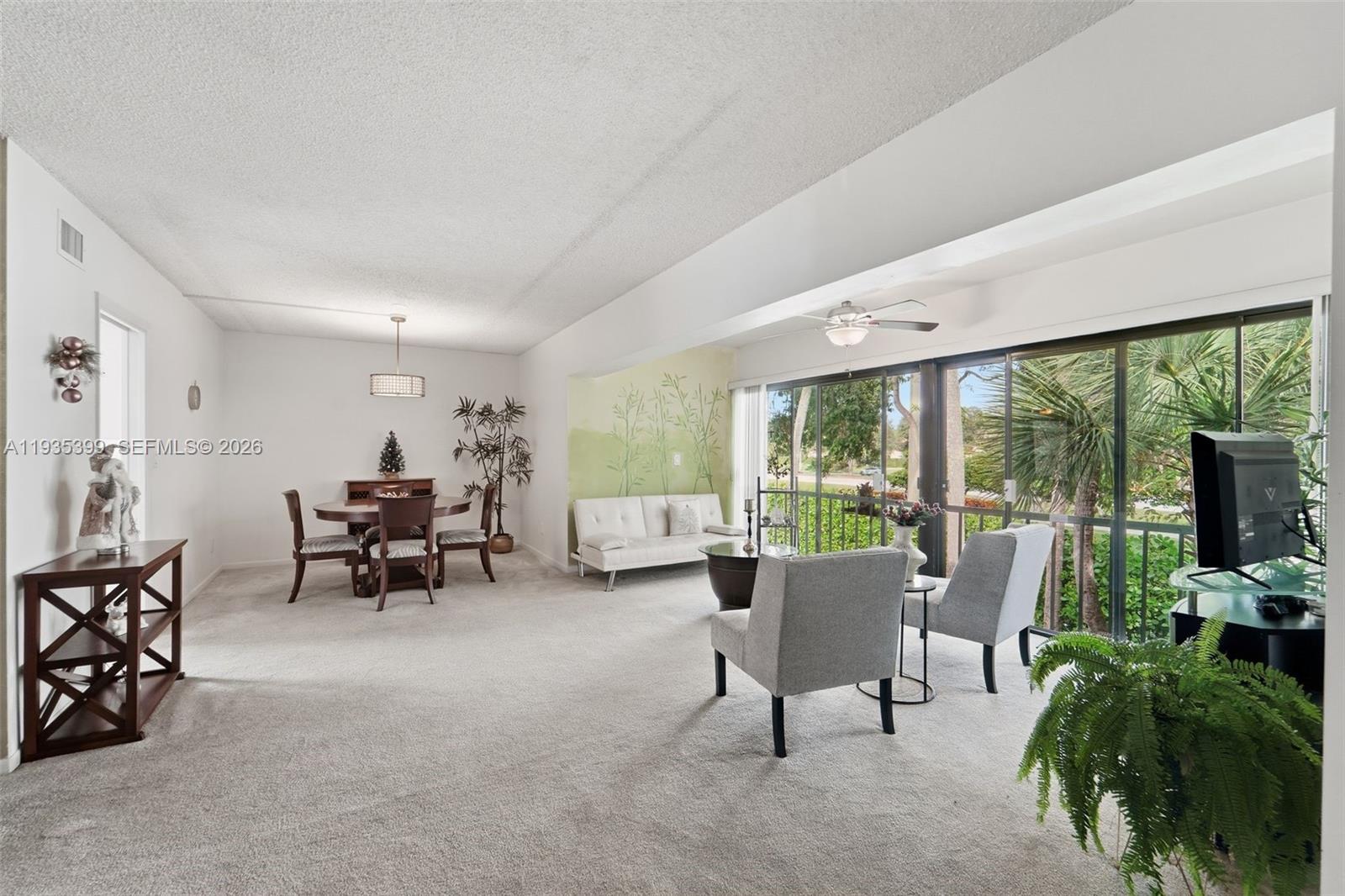 6561 Spring Bottom Way, Unit 234 Boca Raton, FL 33433 - Photo 9 of 33 a living room with furniture and a flat screen tv