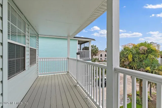 a view of a balcony with wooden floor