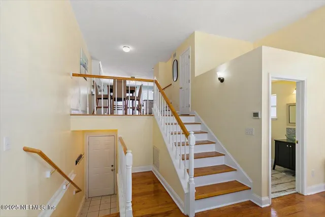 a view of entryway and hall with wooden floor