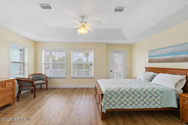 a bedroom with a bed and glass door
