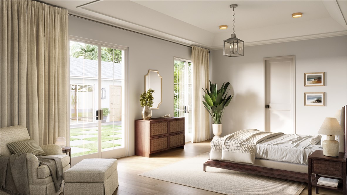 545 Date Palm Road Vero Beach, FL 32963 - Photo 7 of 13 a bedroom with a large bed and a chandelier