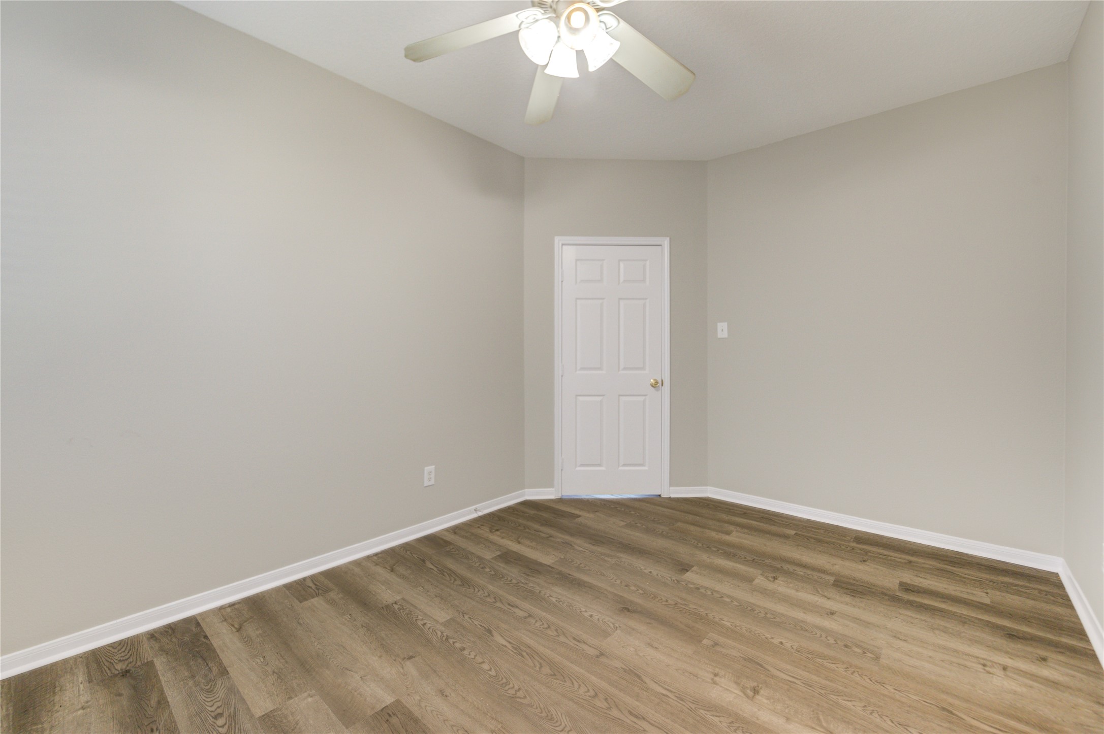 19427 Harvest Stream Way Houston, TX 77084 - Photo 12 of 38 an empty room with a chandelier fan and wooden floor