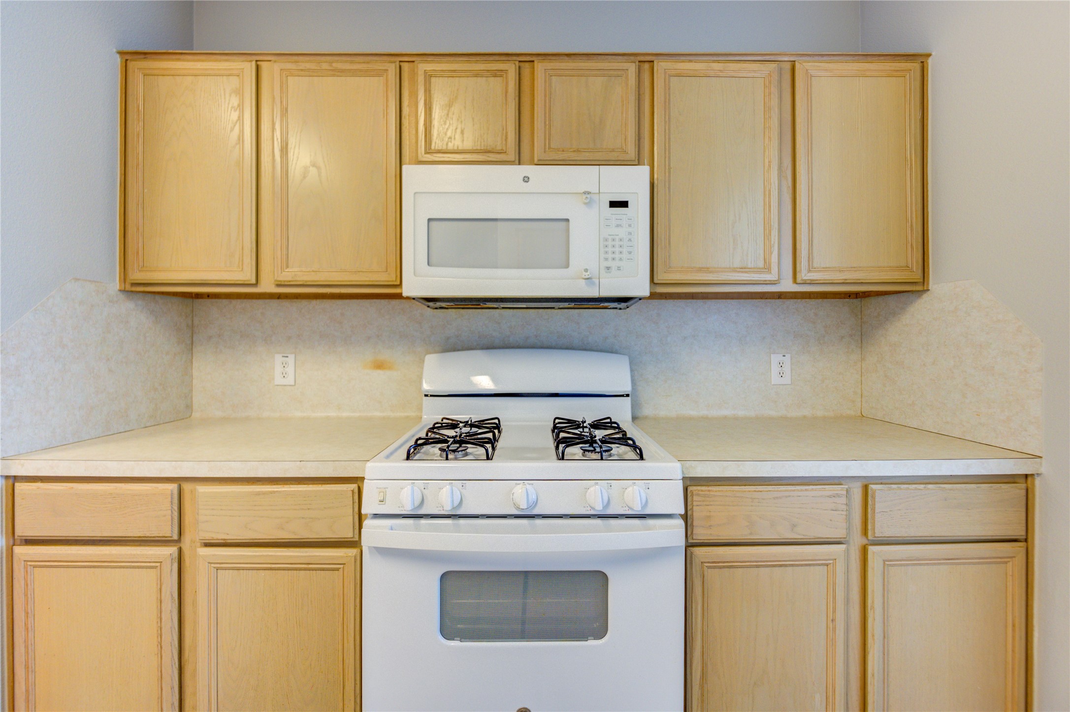 19427 Harvest Stream Way Houston, TX 77084 - Photo 16 of 38 a kitchen with granite countertop white cabinets and white appliances