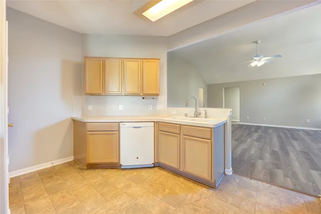 a view of a kitchen with sink cabinets and a window