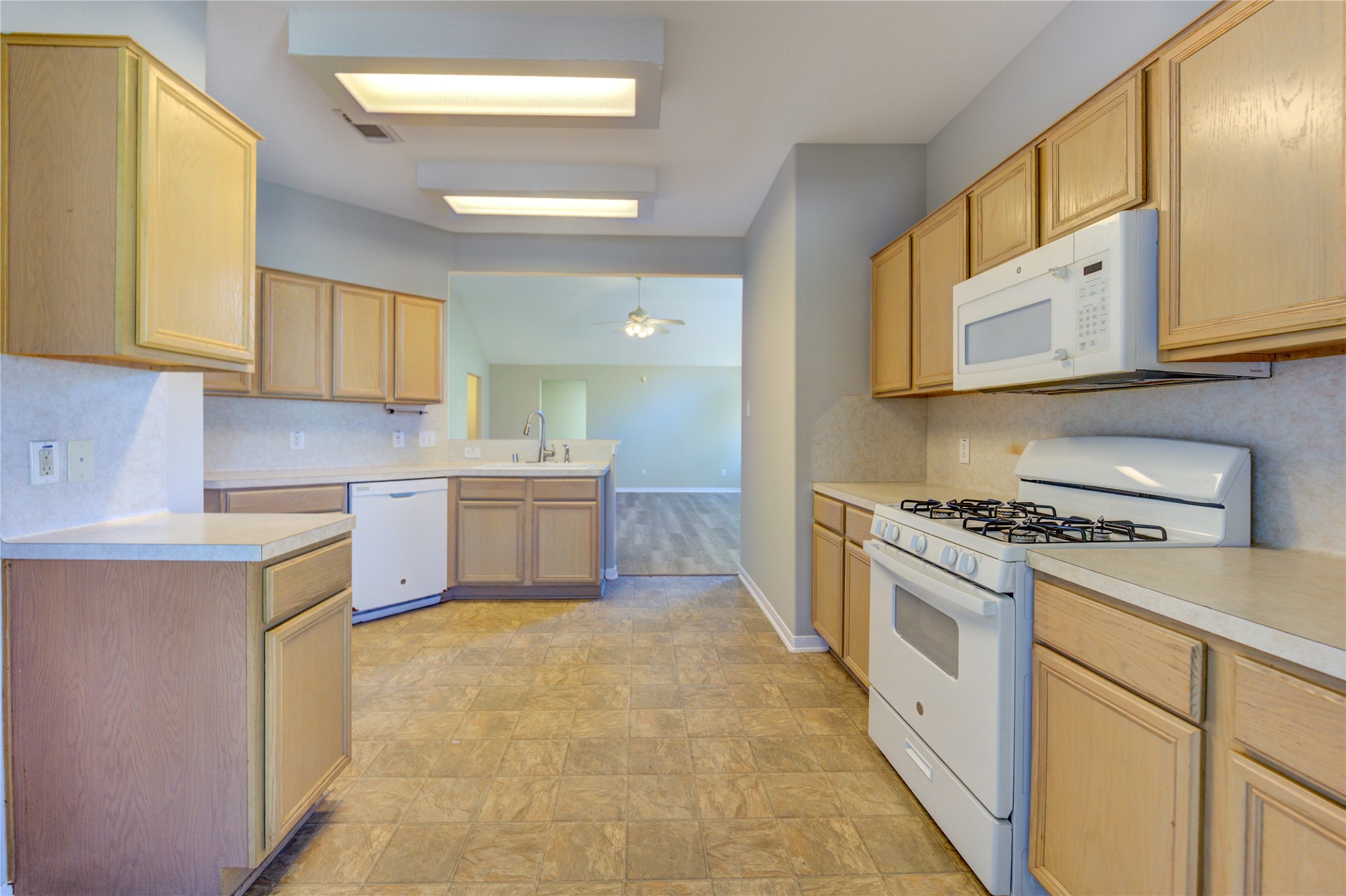 19427 Harvest Stream Way Houston, TX 77084 - Photo 18 of 38 a kitchen with stainless steel appliances granite countertop a stove a sink and a refrigerator