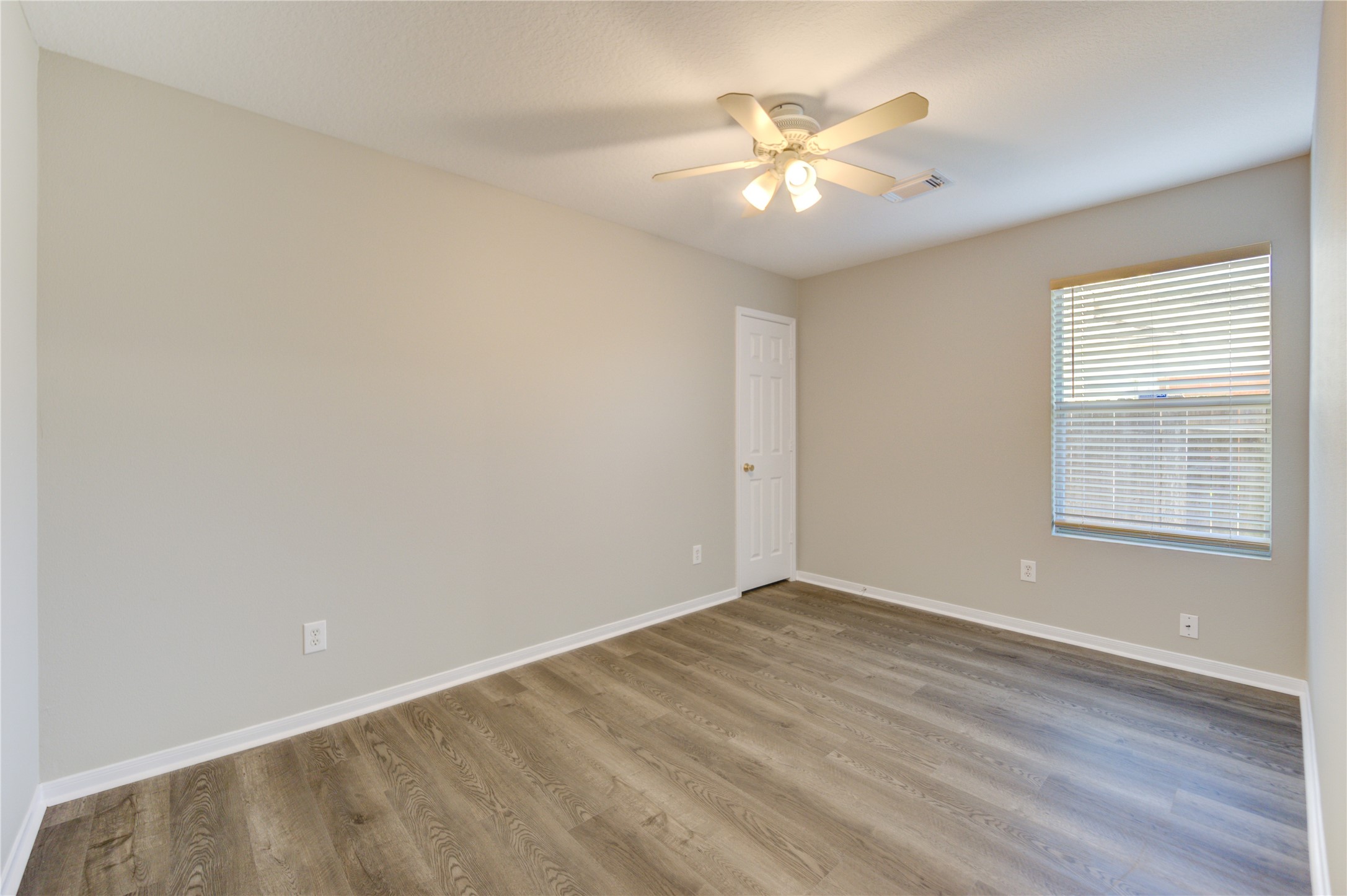 19427 Harvest Stream Way Houston, TX 77084 - Photo 21 of 38 wooden floor in an empty room with a window