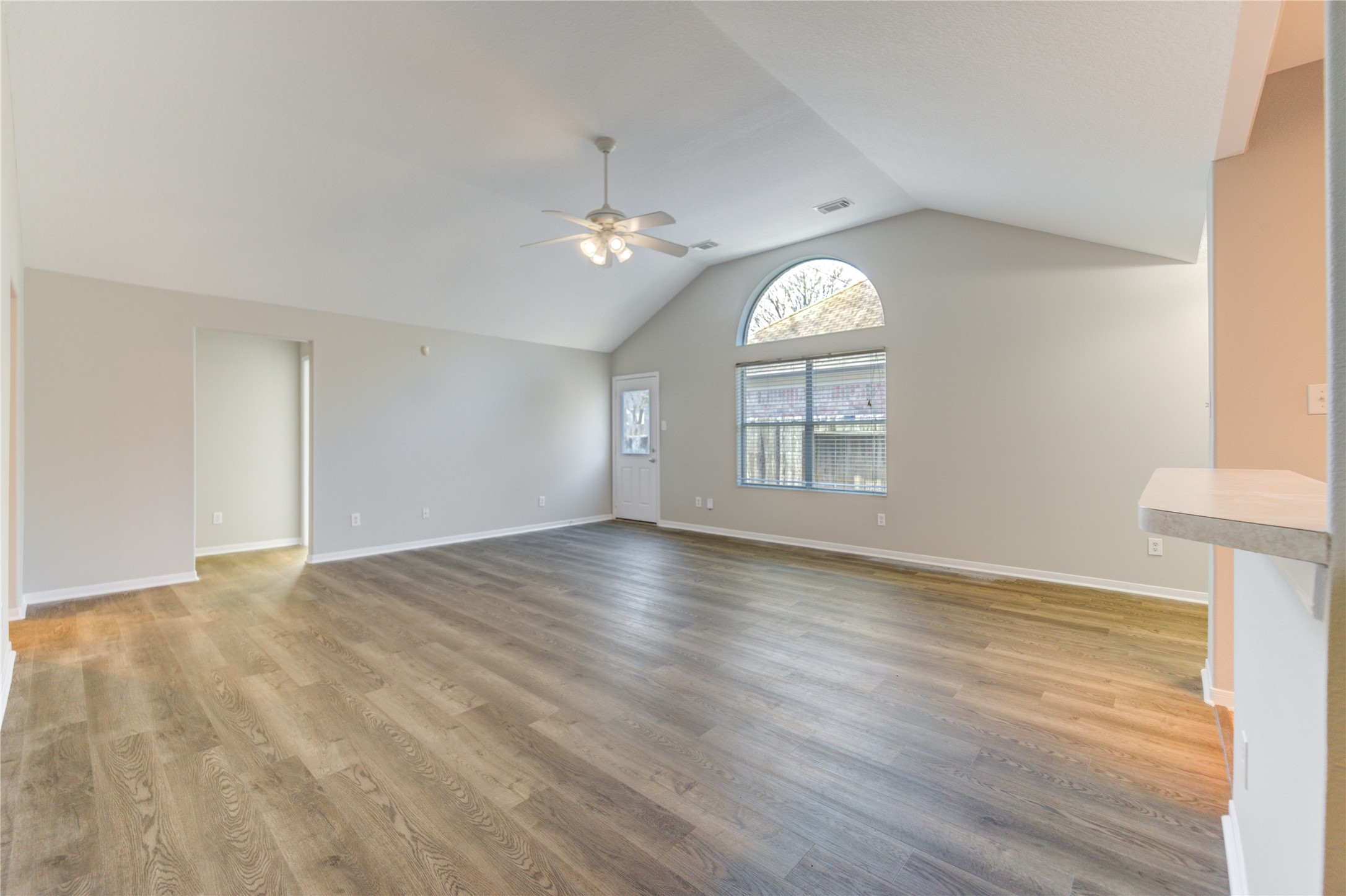 19427 Harvest Stream Way Houston, TX 77084 - Photo 8 of 38 an empty room with wooden floor cabinet and windows