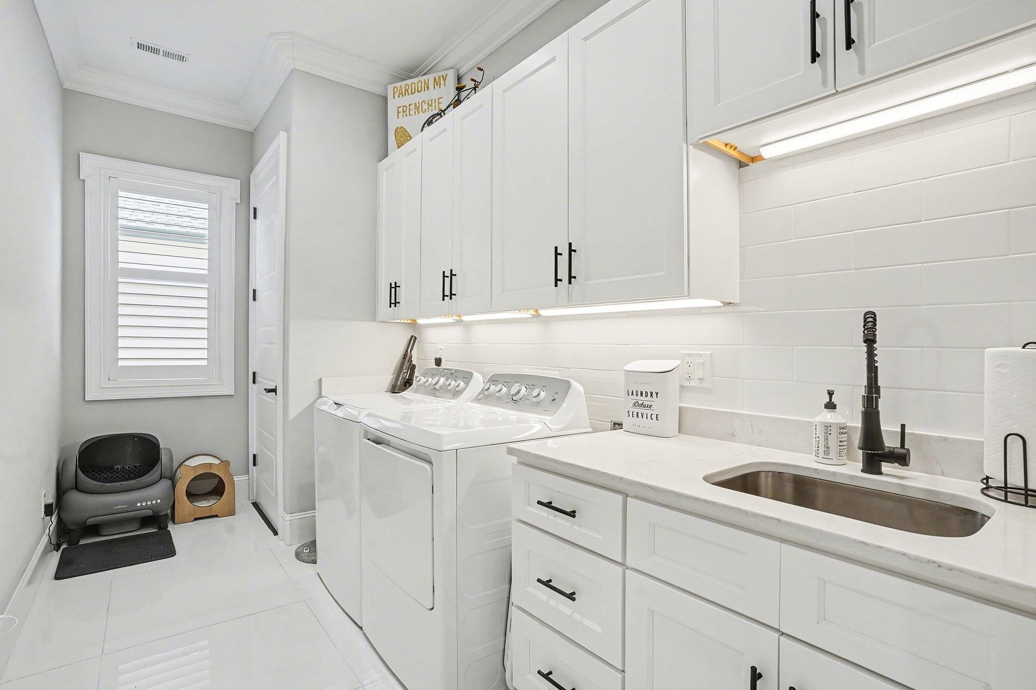 902 Shipmaster Avenue Myrtle Beach, SC 29579 - Photo 27 of 40 Washroom featuring light tile patterned floors, crown molding, cabinet space, and separate washer and dryer