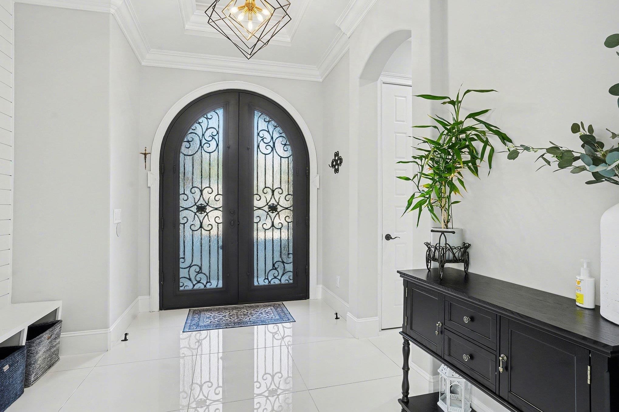 902 Shipmaster Avenue Myrtle Beach, SC 29579 - Photo 3 of 40 Entryway featuring arched walkways, french doors, crown molding, and light tile patterned floors