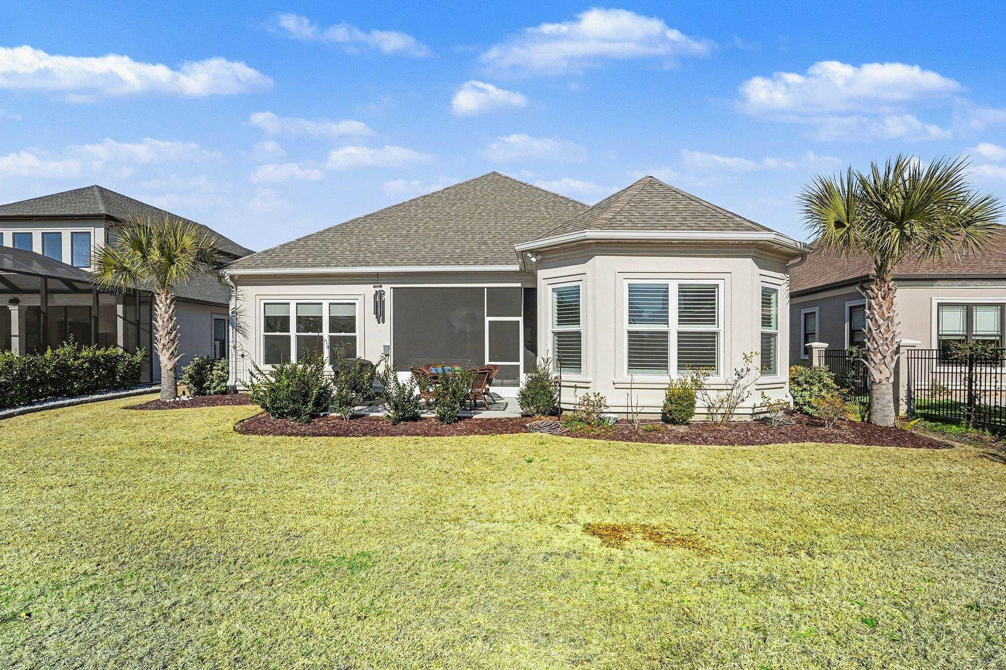 902 Shipmaster Avenue Myrtle Beach, SC 29579 - Photo 34 of 40 Back of house with a sunroom and a shingled roof