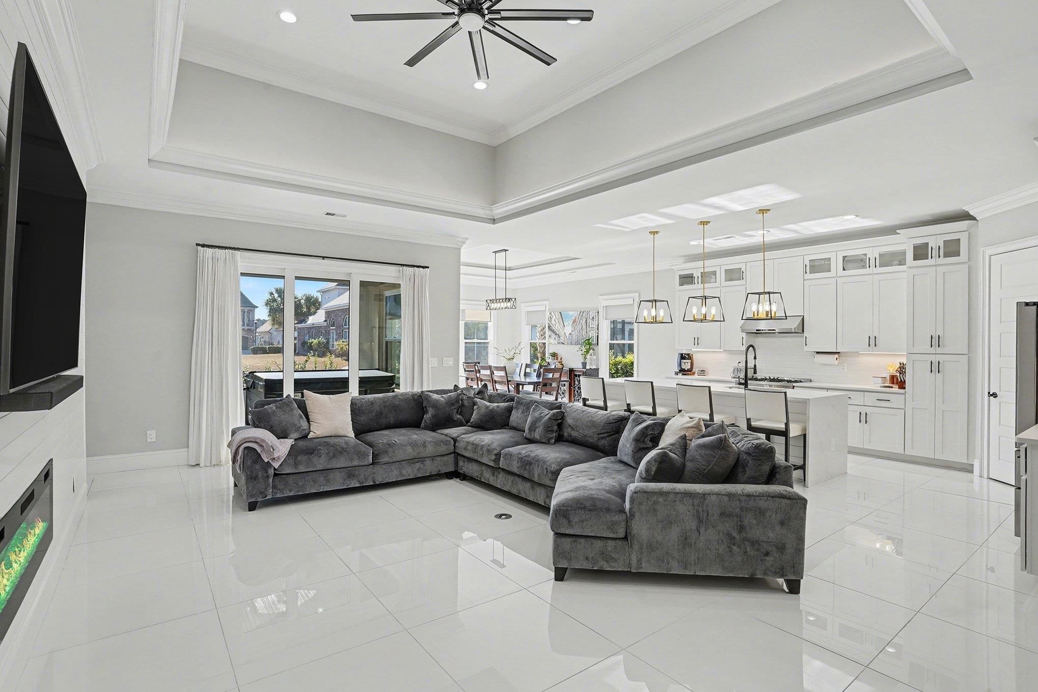 902 Shipmaster Avenue Myrtle Beach, SC 29579 - Photo 6 of 40 Living room featuring ornamental molding, a tray ceiling, healthy amount of natural light, light tile patterned floors, and recessed lighting