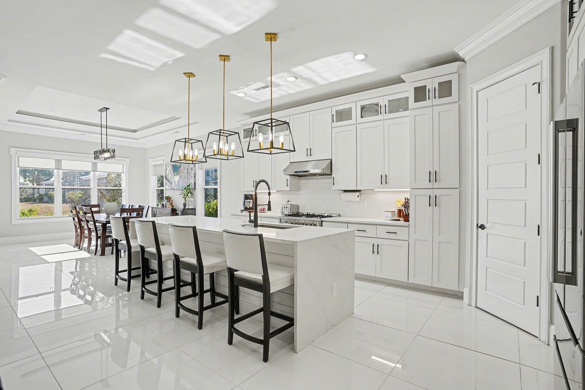 902 Shipmaster Avenue Myrtle Beach, SC 29579 - Photo 7 of 40 Kitchen featuring ornamental molding, a center island with sink, light stone countertops, pendant lighting, and a kitchen bar
