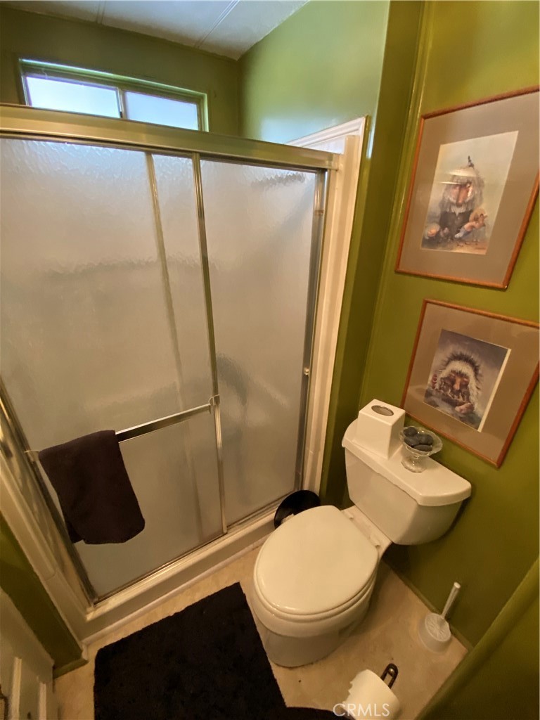 12680 4th Street, Unit 39 Yucaipa, CA 92399 - Photo 24 of 45 a white toilet sitting next to a bathroom sink