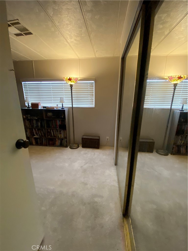 12680 4th Street, Unit 39 Yucaipa, CA 92399 - Photo 27 of 45 a hallway with a car