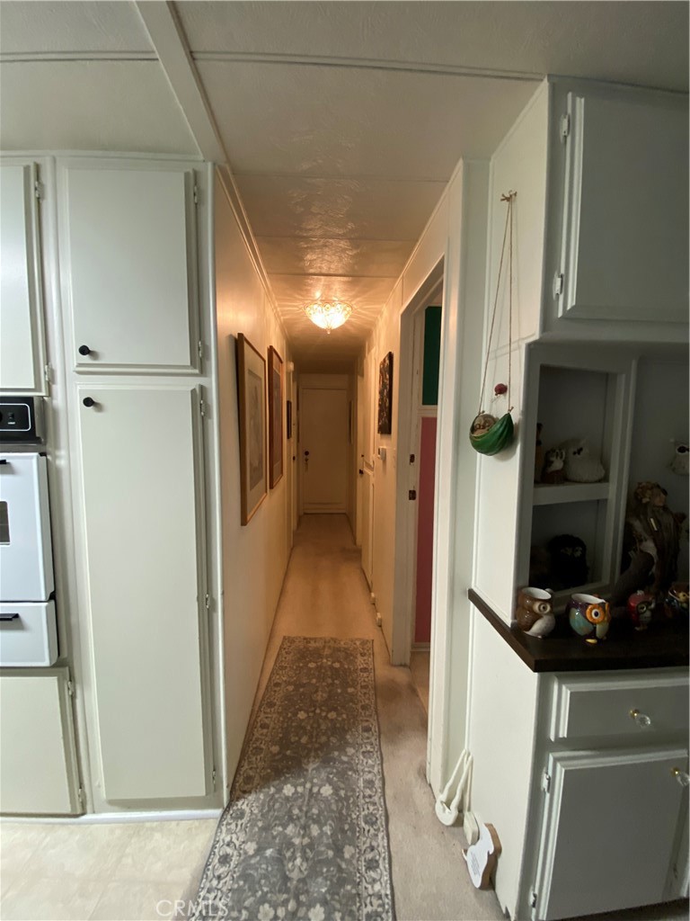 12680 4th Street, Unit 39 Yucaipa, CA 92399 - Photo 28 of 45 a view of hallway with cabinets