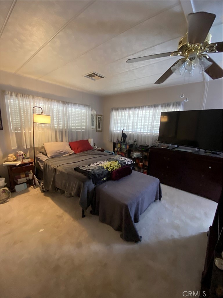 12680 4th Street, Unit 39 Yucaipa, CA 92399 - Photo 29 of 45 a bed room with furniture and a flat screen tv