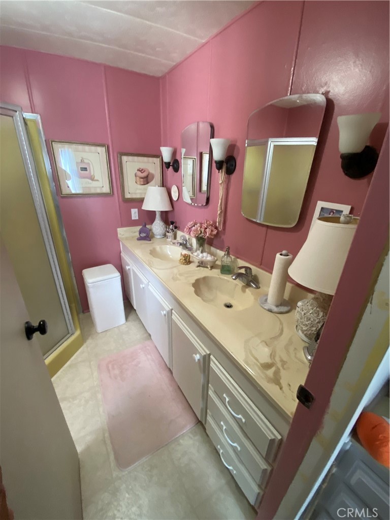 12680 4th Street, Unit 39 Yucaipa, CA 92399 - Photo 31 of 45 a bathroom with a sink mirror and vanity
