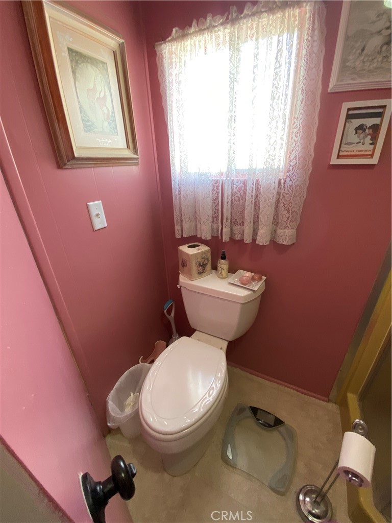 12680 4th Street, Unit 39 Yucaipa, CA 92399 - Photo 32 of 45 a bathroom with a toilet a sink and mirror