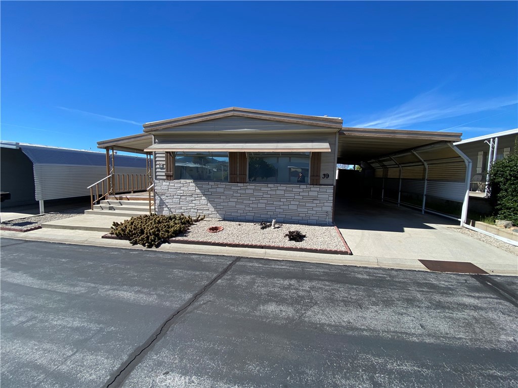 12680 4th Street, Unit 39 Yucaipa, CA 92399 - Photo 4 of 45 a front view of a house with a yard