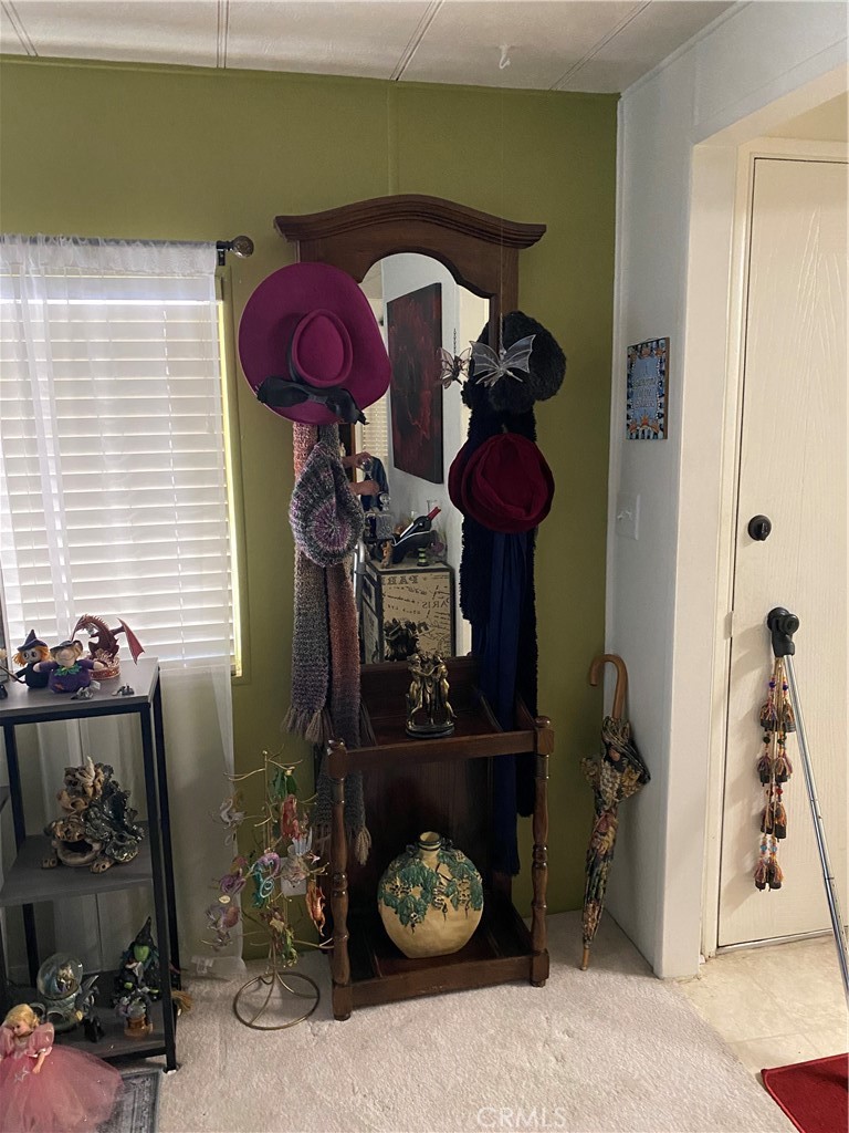 12680 4th Street, Unit 39 Yucaipa, CA 92399 - Photo 8 of 45 a room with a mirror and furniture