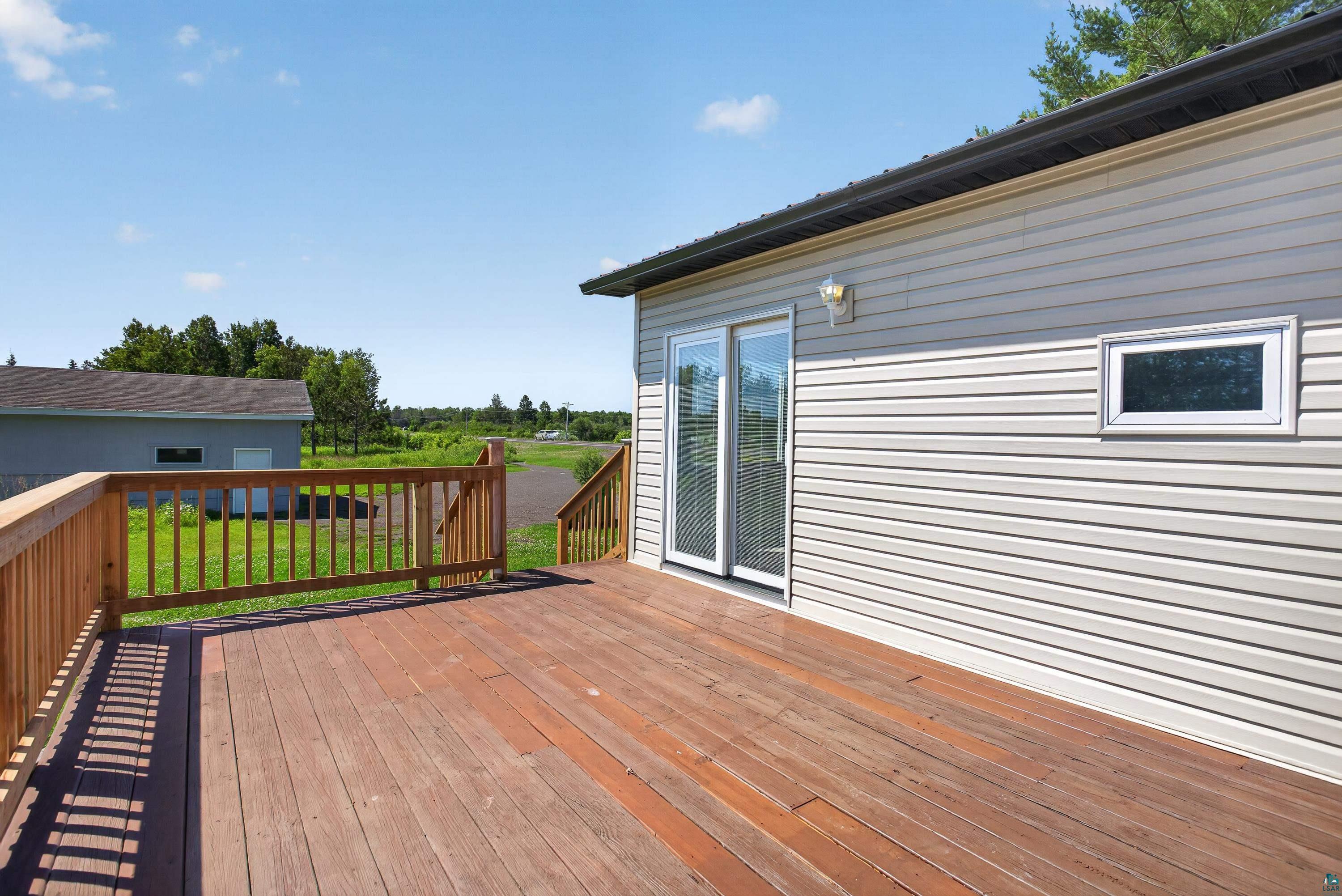 5868 Rice Lake Road Duluth, MN 55803 - Photo 12 of 39 Spacious exterior deck with wood-finish flooring and natural wood railing