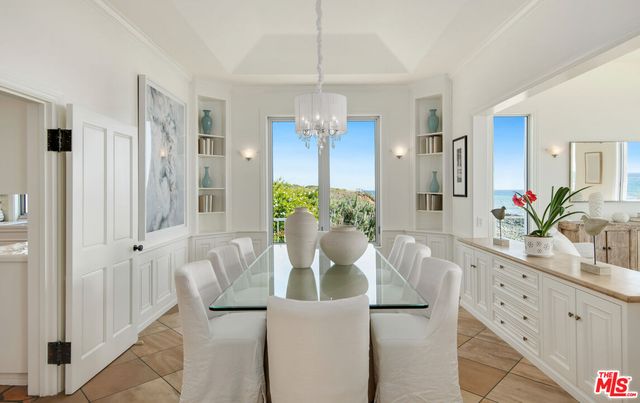 a kitchen with a stove and white cabinets