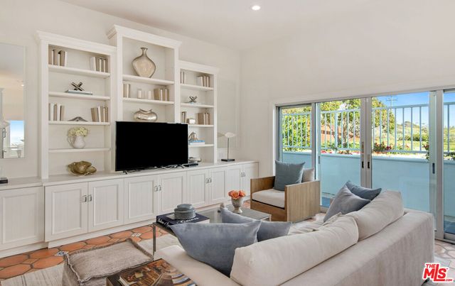 a bedroom with a bed and a television