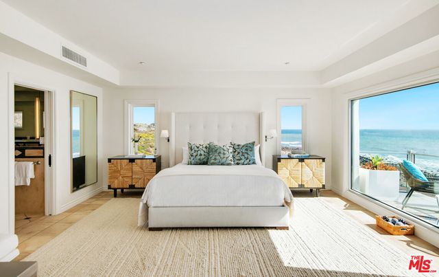 a large white kitchen with a large window