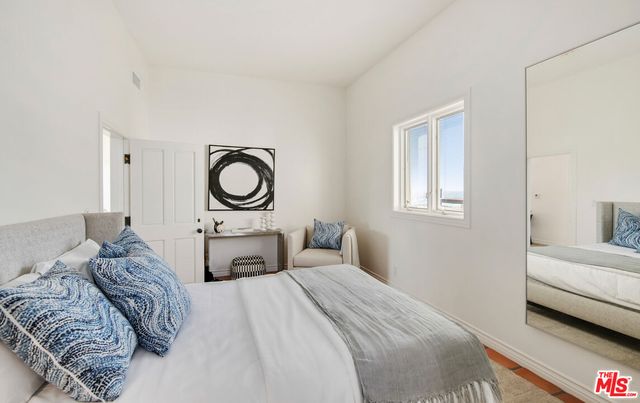 a dining room with furniture and a large window