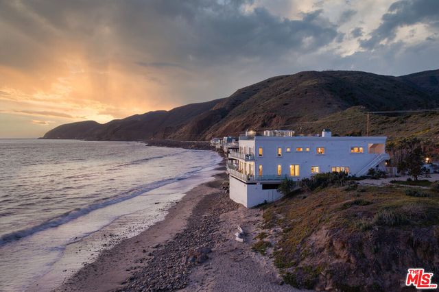 a living room with furniture potted plant and a fireplace