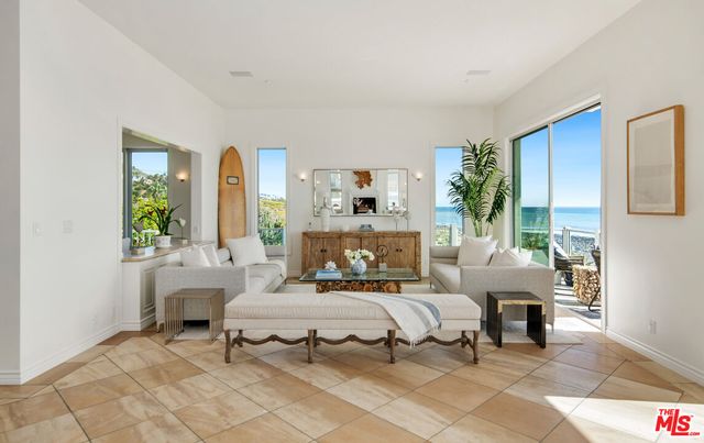 a living room with furniture white walls and a fireplace