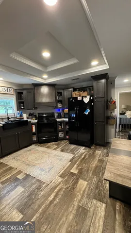 a view of kitchen with refrigerator and chairs