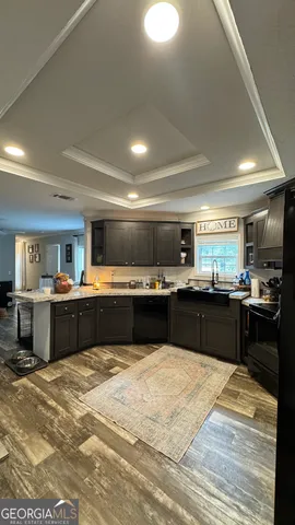 a kitchen with a sink counter top space and stainless steel appliances