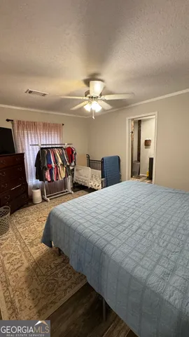 a bedroom with bed and a chandelier