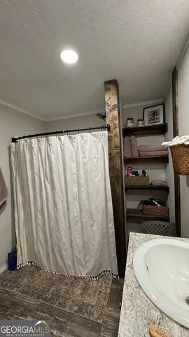 a bathroom with a toilet a sink and a mirror