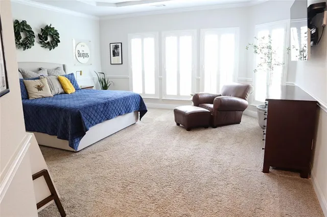 a spacious bedroom with a bed and a couch