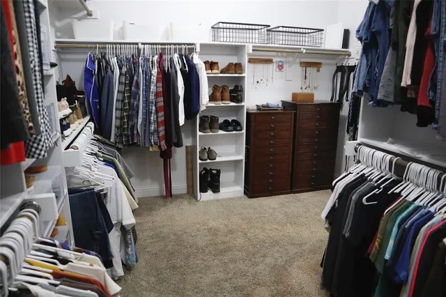 a bathroom with a granite countertop sink a toilet and a shower