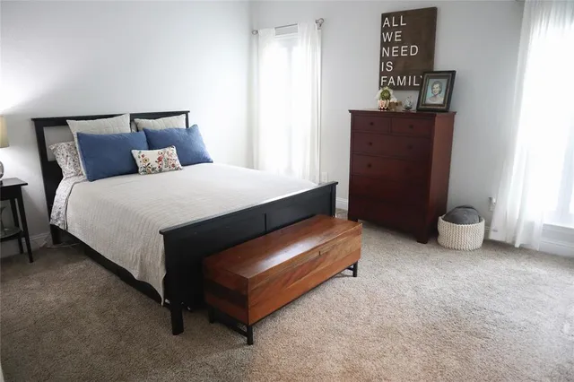 a living room with furniture and a book shelf
