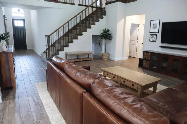 a living room with furniture and wooden floor