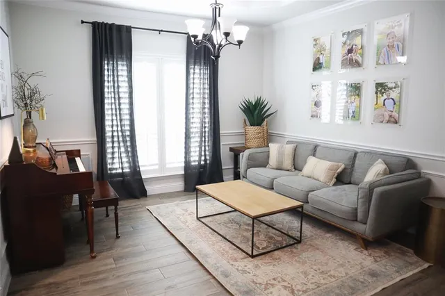 a kitchen with stainless steel appliances granite countertop a table chairs and a refrigerator