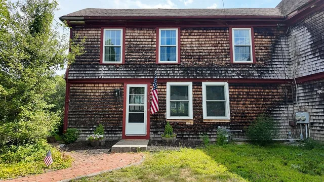 a view of a house with backyard sitting area and garden