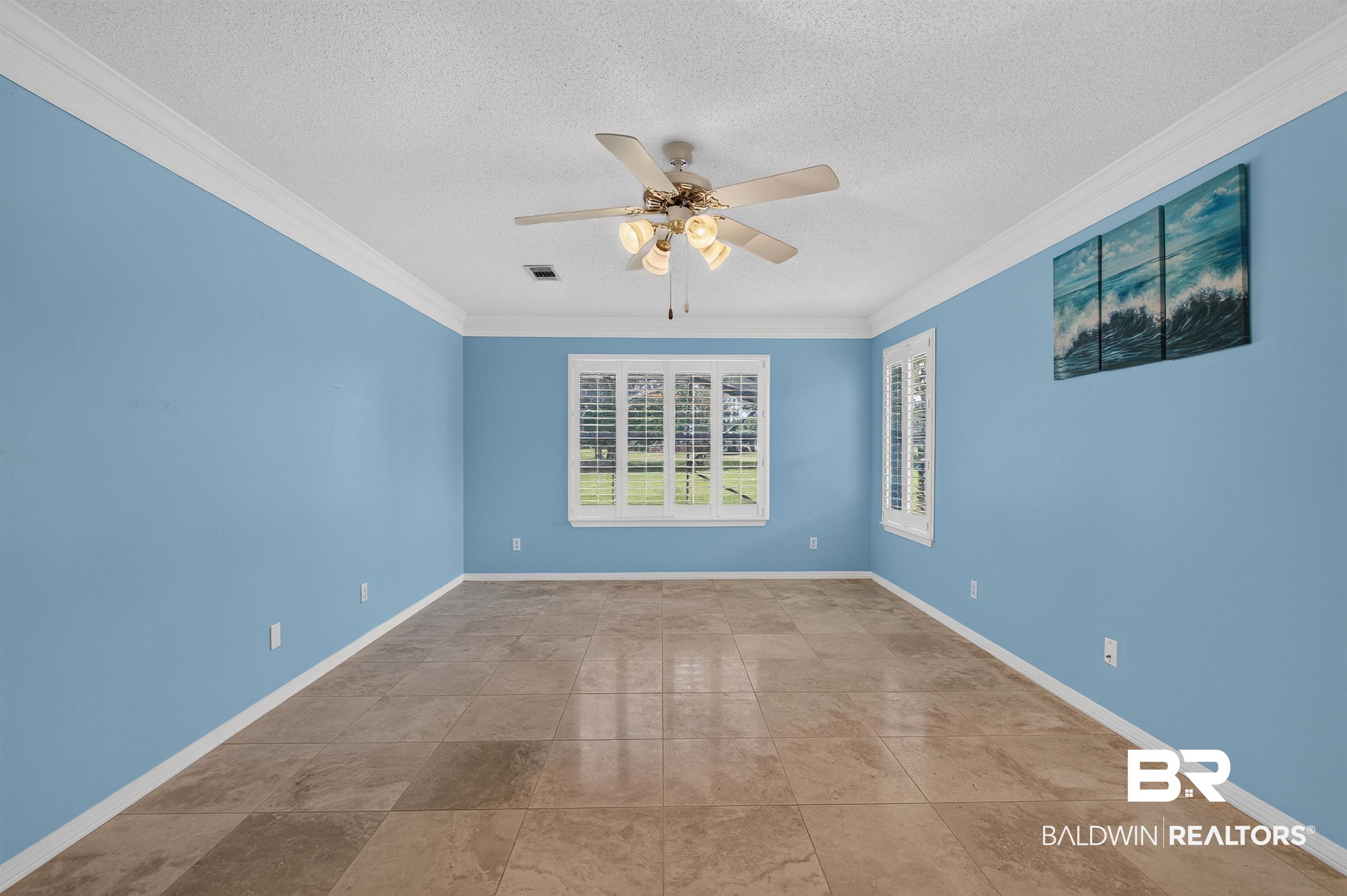 22685 County Road 12 Foley, AL 36535 - Photo 50 of 89 Spacious room featuring tile flooring, white crown molding, plantation-shuttered windows, and a ceiling fan with integrated lighting