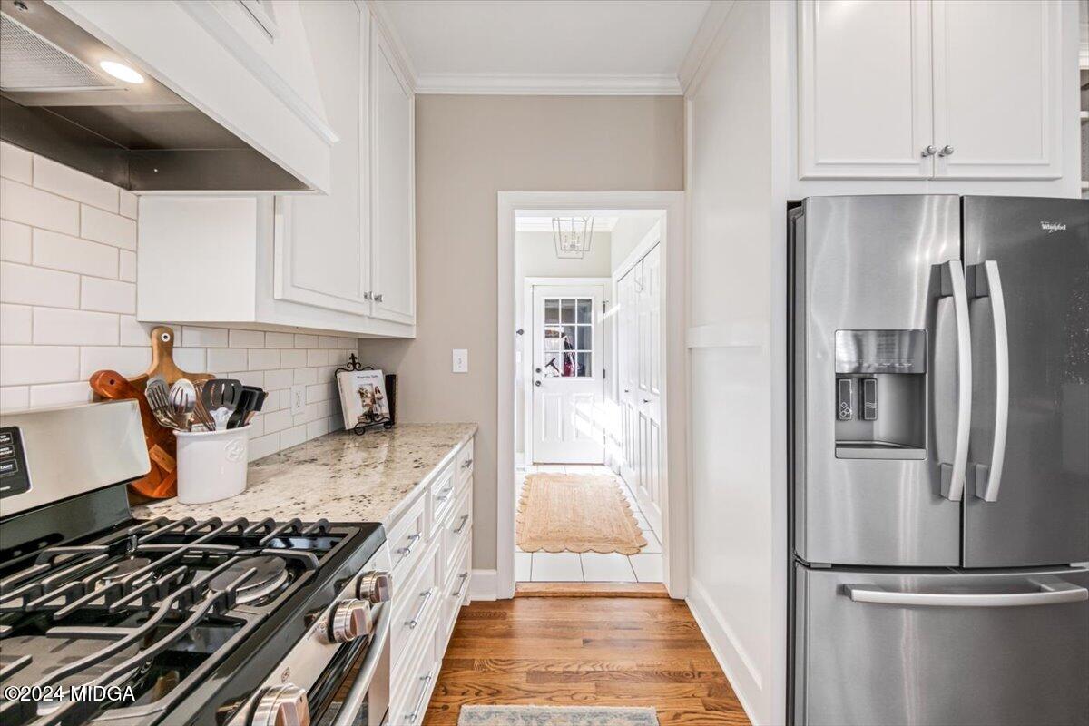 7701 Whittle Road Macon, GA 31220 - Photo 11 of 56 a kitchen with granite countertop stainless steel appliances and wooden cabinets