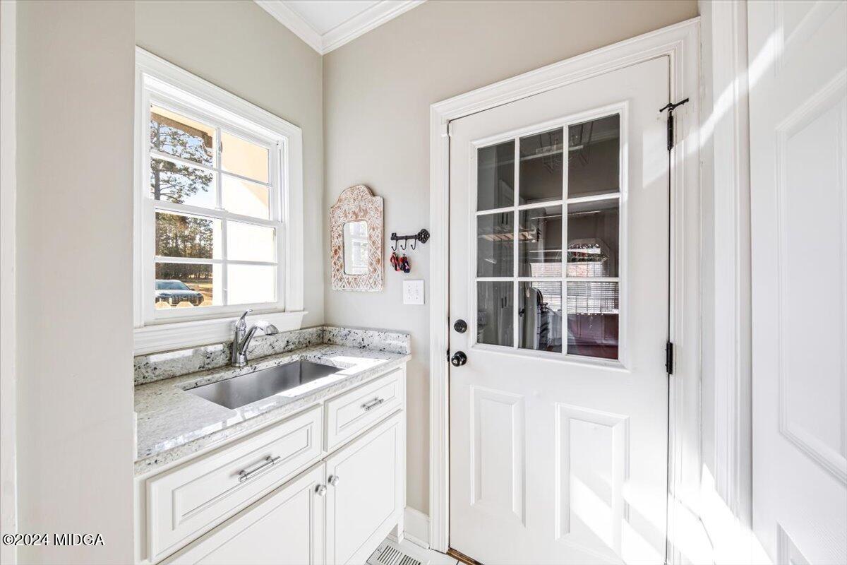 7701 Whittle Road Macon, GA 31220 - Photo 14 of 56 a kitchen with a sink window and cabinets
