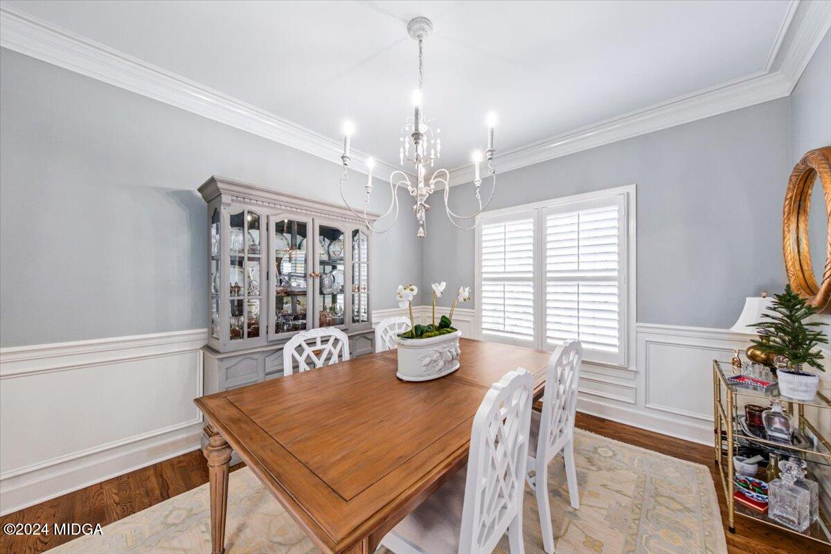 7701 Whittle Road Macon, GA 31220 - Photo 21 of 56 a dining room with furniture potted plants and wooden floor