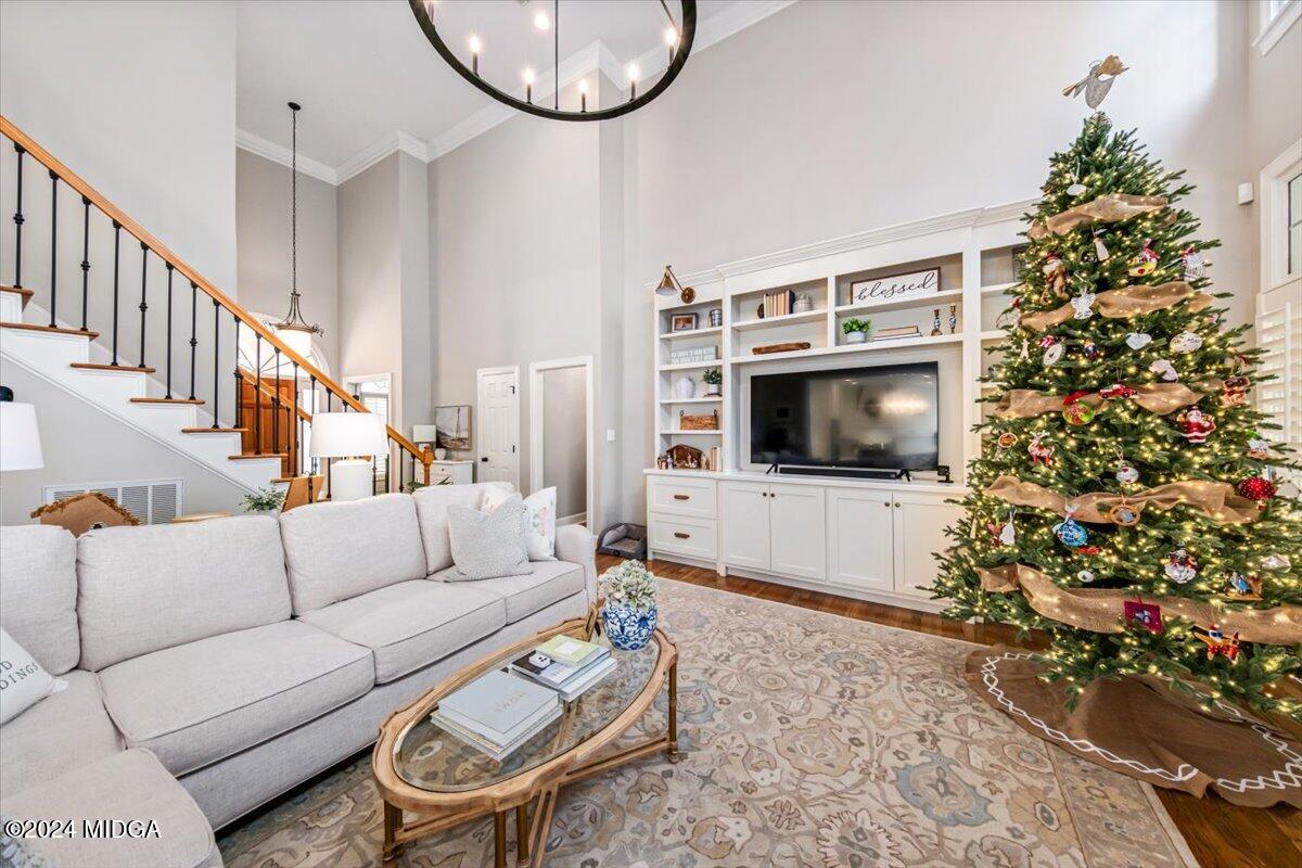 7701 Whittle Road Macon, GA 31220 - Photo 22 of 56 a living room with furniture a flat screen tv and a potted plant