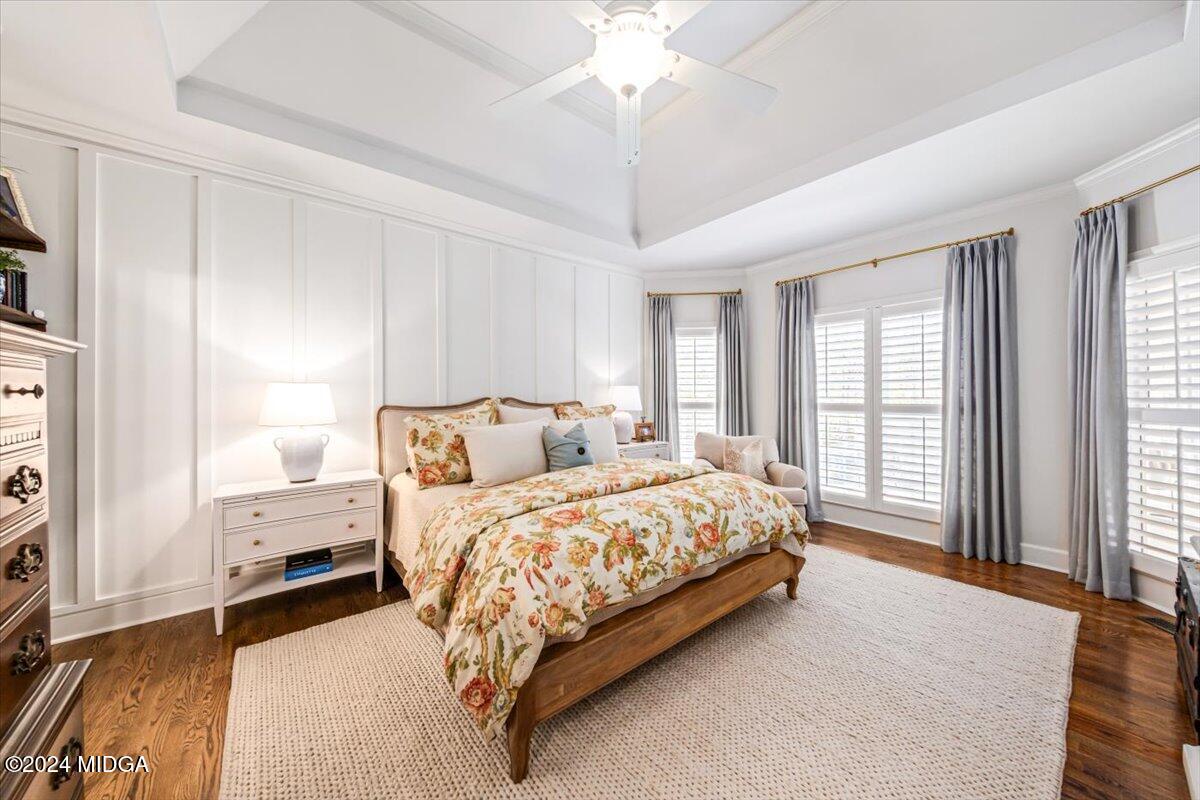 7701 Whittle Road Macon, GA 31220 - Photo 24 of 56 a bedroom with a large bed and a chandelier fan